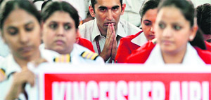Kingfisher employees protesting against the airline in New Delhi on Tuesday. The DGCA has asked the carrier to stop selling tickets until its concerns are resolved. 