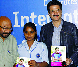 Actor Anil Kapoor with a schoolgirl releases a report of ''Learning for Life'' 