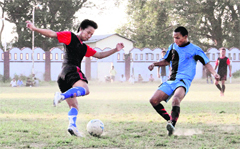 Players in action during a match in the Lala Nemi Dass Memorial Football Tournament under way at Survey Stadium in Dehradun on Tuesday.