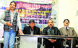 A speaker highlights the role of the Department of Posts on the occasion of World Postal Day in Mussoorie on Tuesday