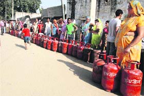 People queue up for refills outside an LPG agency in Gurgaon on Tuesday