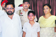 The kidnapped boy along with his parents after being rescued from a hotel in Jalandhar. 