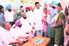 Congress leaders, including Capt Amarinder Singh and Sunil Jhakar, interact with residents at a village near Amritsar on Tuesday.