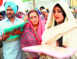 Bollywood actor Ajay Devgn (left), actress Sonakshi Sinha (right) and her mother Poonam Sinha (centre) pay obeisance at the Golden Temple in Amritsar on Wednesday