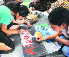 Students of the University Institute of Engineering and Technology (UIET) participate in a poster-making competition at Panjab University in Chandigarh on Wednesday. 