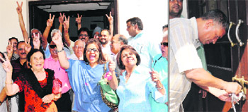 Members of Central Club in a jubilant mood; and (right) estate office employees open the seal of the gate on Wednesday. 