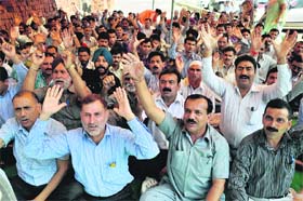 Members of J&K Government Employees Joint Consultative Committee protest in front of the Divisional Commissioners office in Jammu on Wednesday