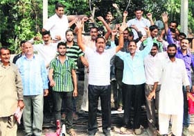 Members of the PDD daily wagers union stage a protest in support of their demand in Reasi on Wednesday