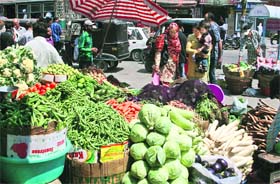 People buy vegetables from a shop in Srinagar