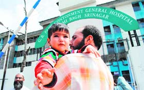 A man takes his child for treatment to the GB Pant Hospital in Srinagar