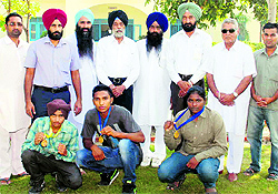 Pugilists of Shri Ram College, Dalla, with their medals at a function at Jagraon