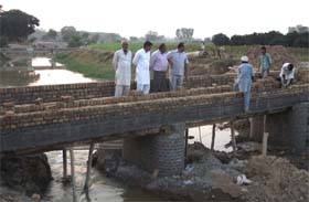 Officials of the Drainage Department inspect the construction of water courses on the Abulkhurana drain
