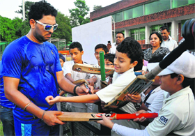 Cricketer Yuvraj Singh gives autographs to young fans at the cricket stadium in Sector 16, Chandigarh, on Thursday after attending a practise session. Yuvi is in city to shoot for a documentary on cancer patients