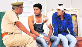 A police official talks to injured students at General Hospital, Sector 6, Panchkula, on Thursday. 