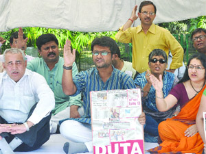 Teachers under the banner of DUTA during the indefinite relay hunger strike for their various demands in front of VC office at Delhi University in New Delhi on Thursday. 