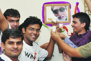Students of KMC offer cake to the photograph of Amitabh Bachchan on his 70th birthday at room number 65 of the college hostel, where Amitabh used to stay during his college days in New Delhi on Thursday. 