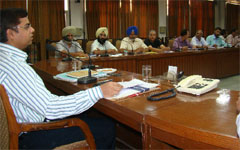 ADC Mohammed Tayyab presiding over a meeting on economic census on Friday. A Tribune photo