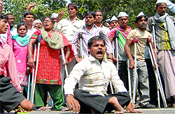 The physically challenged people march towards the Prime Minister's residence to protest against Union Law Minister Salman Khurshid in New Delhi on Friday