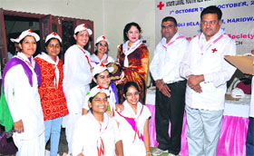 Director of Defence Audit Aastha Kurwe presents trophies to best volunteers from Haryana at the conclusion of a study camp of the Indian Red Cross Society in Haridwar on Friday.