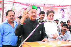 Virbhadra Singh addresses a public rally at Kholi near Kangra on Friday. 
