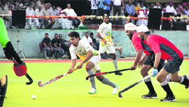 Players of Northen Railway and CRPF (in red dress) in action during the 29th Indian Oil Surjit Hockey Tournament in Jalandhar on Friday.