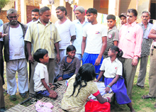 Family mourns the childs death in Jalandhar. The gutter in which the child fell. 