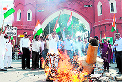 Activists of the India Against Corruption (Amritsar Unit) burn the effigy of Union Law Minister Salman Khurshid in Amritsar on Saturday