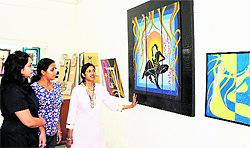 Visitors take a look at paintings of Meenu Sharma at an exhibition at a Art Gallery in Amritsar on Saturday