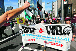 Protesters march with a banner after a rally against the annual IMF-World Bank meetings in Tokyo on Saturday. About 300 demonstrators, some waving wads of fake note bills and dressed in grotesque costumes meant to mimic the super rich, walked down downtown Tokyos luxury shopping street near the meeting's venue. The banner reads "No more IMF and WB's rule over the world economy."