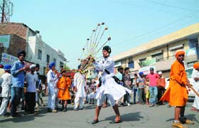 A youth demonstrates his martial arts skill during the procession