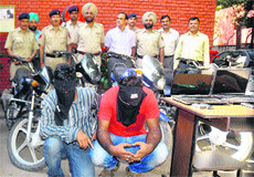 The accused along with recovered vehicles and latop in police custody at the Sector 11 police station, Chandigarh, on Saturday.