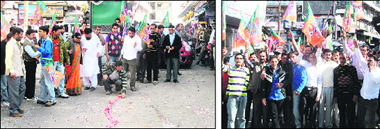 BJP workers burst crackers (left) and raise slogans to celebrate the partys victory in the Tehri bypoll in Mussoorie on Saturday.