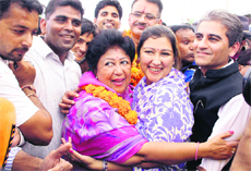 Mala Raj Lakshmi Shah hugs her daughter Ksheerja and son-in-law Sameer after winning the Tehri byelection in Dehradun on Saturday.
