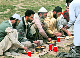 People enjoy their lunch at a park in Srinagar on Saturday.