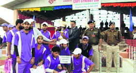 Players of the Star Cricket Club with the winning trophy at the Budgam sports stadium in central Kashmir on Saturday.
