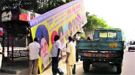 Municipal Corporation staff remove a hoarding from the Gill Road in Ludhiana on Saturday.