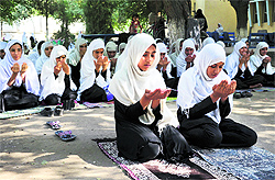 Students pray for the early recovery of Pakistani child activist Malala Yousafzai during a rally in Jalalabad on Saturday