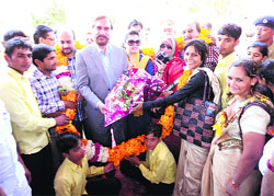 Villagers welcome Pakistan human rights activist Ansar Burney on reaching Laadpur village in Jhajjar on Sunday.
