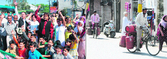 Activists stage a protest against the LPG crisis in Jammu on Sunday; and (right) Employees of a gas agency carry LPG cylinders for home delivery.
