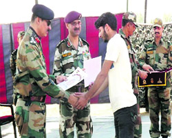 An Army official distributes certificate to a trainee in Srinagar on Sunday. 