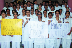 College girls hold placards deploring the attack on Pak child rights activist Malala Yusufzai.