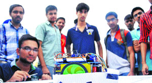 A participant shows his robot during the fest at the UIET on Monday