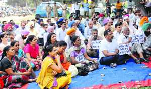 Employees hold a protest under the banner of the Employees Sangharsh Committee in Chandigarh on Monday.