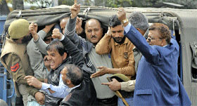 Protesting employees being detained by the police in Srinagar on Monday.