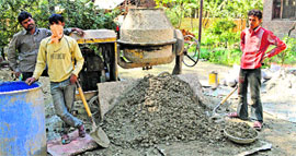 Non-local labourers and wet mixers at work in Hawoora Mishpora village in Qaimoh block of Kulgam district.