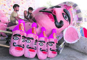Artists prepare an effigy of Ravana ahead of Dasehra in Ludhiana on Monday.