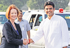 Australian Prime Minister Julia Gillard shakes hands with Minister of State for Communication Sachin Pilot in New Delhi 