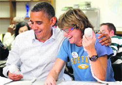 Barack Obama makes calls from a campaign office in Virginia with campaign volunteer Suzanne Stern. 