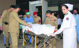 An Army medical team wheels away child activist Malala Yousufzai to an air ambulance in Rawalpindi. 