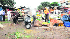 Vegetable merchants sell fresh vegetables in the open at the wholesale fruit and vegetable market, Vallah, in Amritsar. 